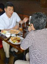 Social worker speaks with woman raising grandson in Tokyo suburb