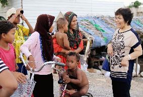 Japanese nurse speaks with residents in Phnom Penh slum