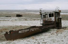 Fishing boat left abandoned on empty Aral Sea spot