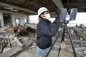 Fukushima museum curator scans tsunami-hit office for 3D data