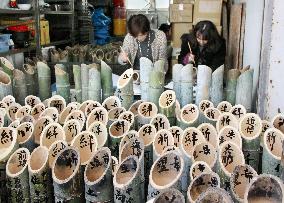 Calligraphers write 2011 disaster victims' names on bamboo lanterns