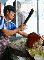 Vendor chops lechon roast pig in Cotabato, Philippines