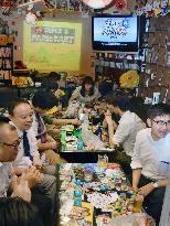 Customers at Osaka bar enjoy old video games, "dagashi" sweets