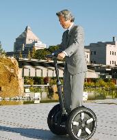 Koizumi rides 'Segway' scooter to office