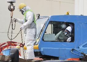 Workers in radiation-proof suits at Fukushima nuclear plant