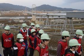 Vistors view huge belt conveyor in quake-hit area