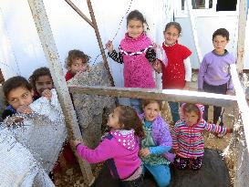 Syrian children play at refugee camp in Jordan