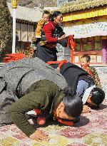 Worshippers pray at Tibetan Buddhist temple in China's Gansu