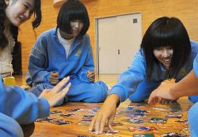 Students in tsunami-hit town enjoy playing cards in dialect