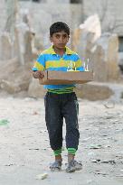 Boy walks in Gaza, still in ruins decade after Israeli withdrawal