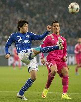 Japan defender Uchida of Schalke fights for ball with Ronaldo