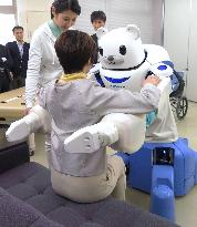 Nursing care robot capable of lifting, helping patient stand up