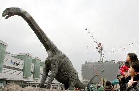 Dinosaur statue appears before railway station in Fukui, western Japan