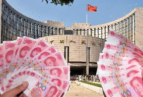 China cuts benchmark interest rates amid economic slowdown