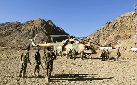 Afghan soldiers stand guard near Remains of Jam