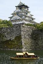 Gilded boat sails in moat around Osaka Castle at tourism blitz event