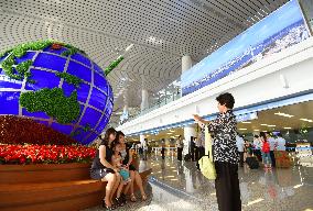 Woman takes photo at new terminal building of Pyongyang airport