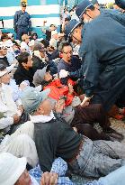 Protesters oppose government move for base relocation