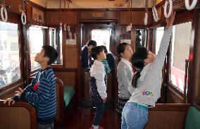 Children visit old train car on display in new railway museum