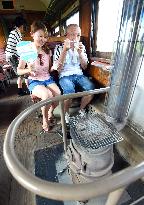 Tourists brave heat to enjoy ride on "stove train" in northern Japan