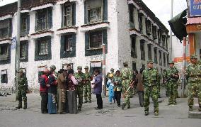 Tibet's capital quiet after riots, armed forces remain in sight