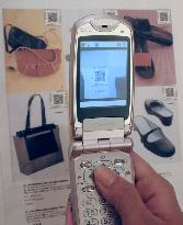 Shopping system based on camera-equipped mobile phones devised