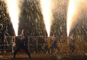 Men brave rain of firework sparks during central Japan festival