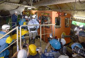 Firefighters carry injured in Seikan Tunnel train disaster drill