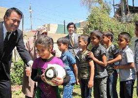 Japanese football official gives Iraqi orphans soccer balls