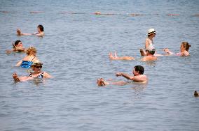 Tourists enjoy floating on Dead Sea