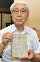 Head of poet Kenji Miyazawa study group shows notebook