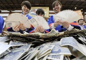 Bankers count money offered at shrine