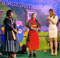 Thai woman in Japanese tea-picking costume on stage at Bangkok event