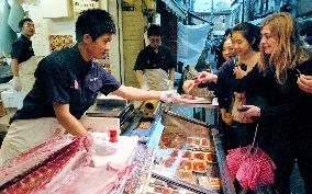 Tuna shop in Tsukiji Outer Market offers fresh meat after filleting