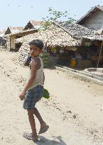 Boy walks in Rohingya refugee camp in western Myanmar