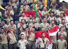 Indonesian soldiers cheer at Asian Games