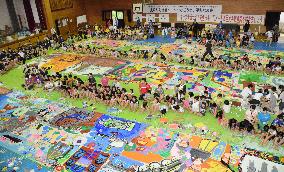 Hundreds of children paint giant peace mural in Nagasaki