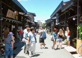 Street with old Japanese houses lures foreign tourists in Takayama