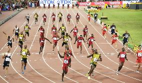 Bolt edges Gatlin to retain world 100m title