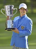 Japanese golfer Ishikawa shows off victory cup