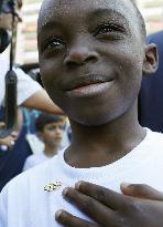 Boy shows off Olympic-ring pin badge