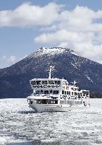 Sightseeing boat Mashu Maru breaks ice on Lake Akan