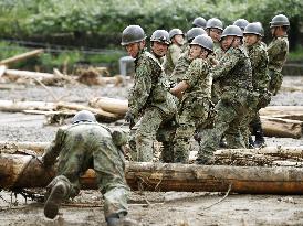 Self-Defense Force personnel remove driftwood in disaster-hit area