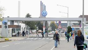 Volkswagen employees walk in front of German factory