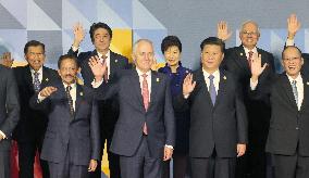 Abe waves at APEC summit photo session
