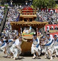 Men tow ship-shaped float at Nagasaki Kunchi festival