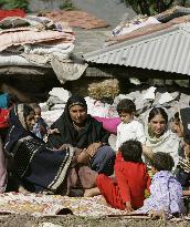 Women, children spend days in front of collapsed house