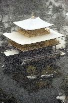 Snow falls on Kyoto's Golden Pavilion