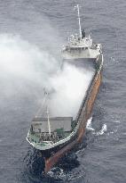 Smoke still spews from Cambodian ship 2 days after fire