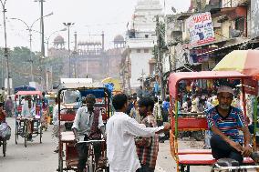 Old Delhi downtown remains flooded with people, tricycles